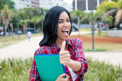 female student showing thumbs up